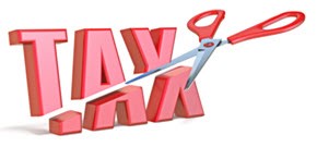 A pair of scissors cutting the word tax in half.
